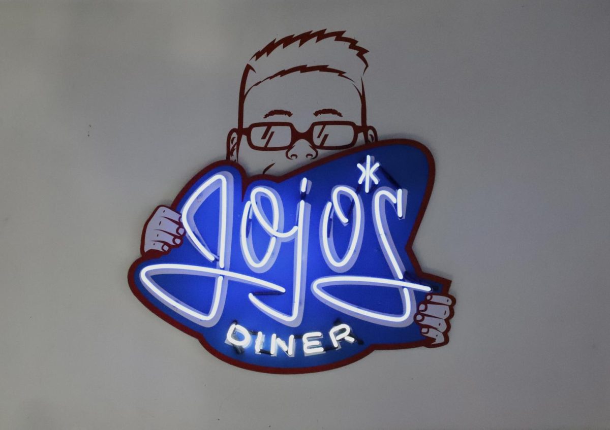 “Jojo’s Diner” LED sign hung up on wall.