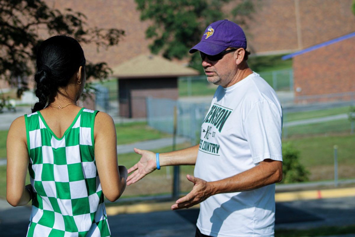 Coach Mark Meier guiding students during cross country.