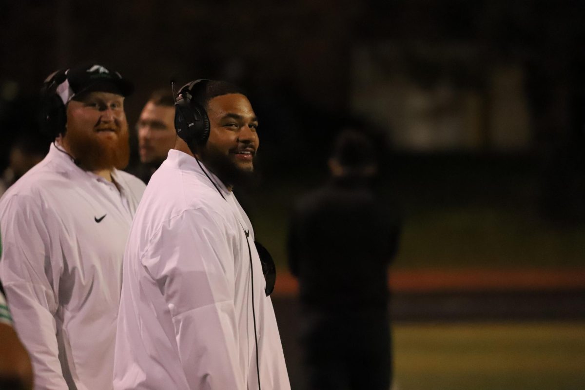 Assistant coaches Jayden Swensen and Jacob Gigax in the football season opener at home.