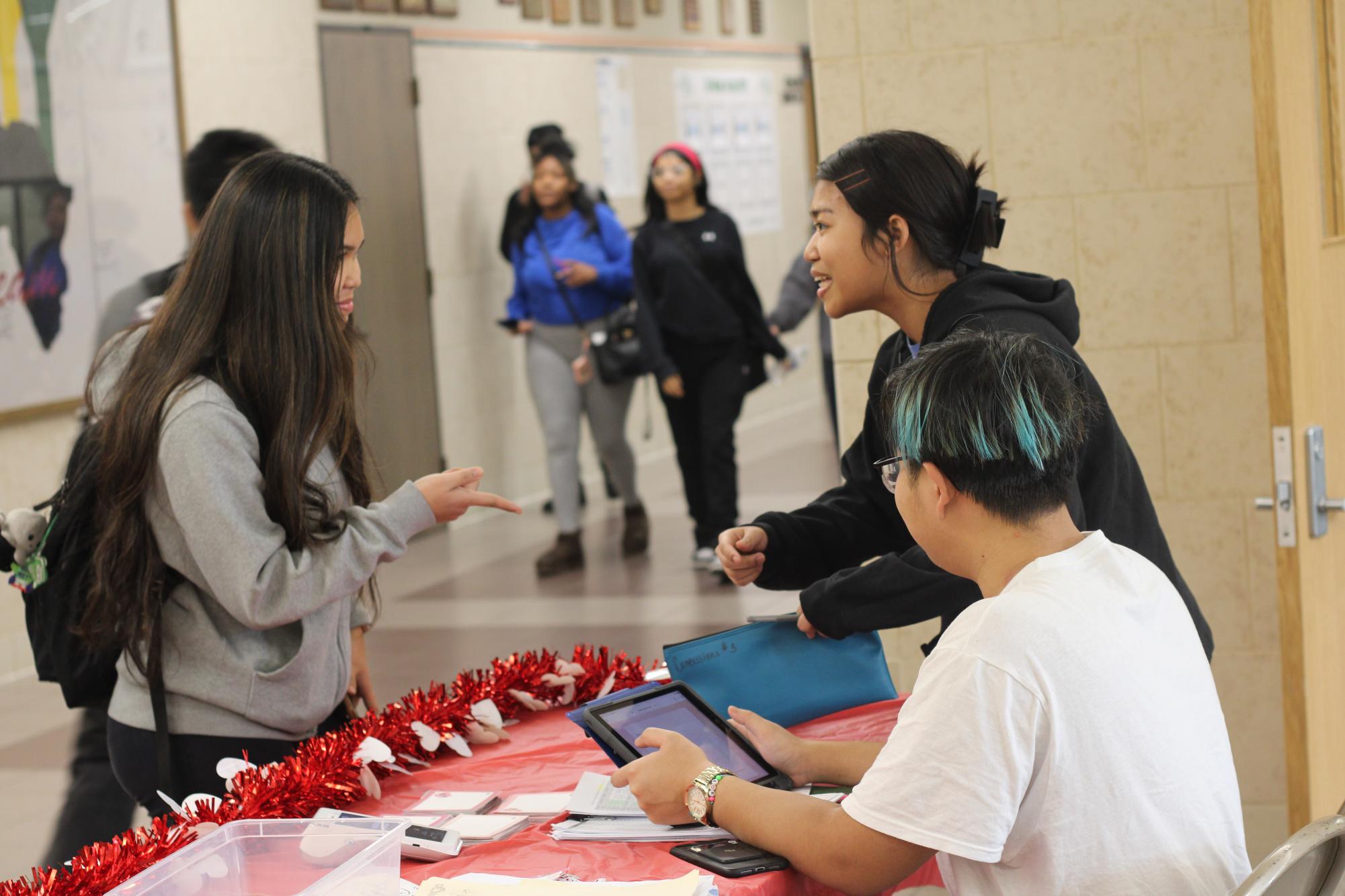 Sophomore senator Sarah Htoo manages money and explains payment options at the Valentine’s Day candy gram table the week before Valentine’s Day to fundraise for future student council events.