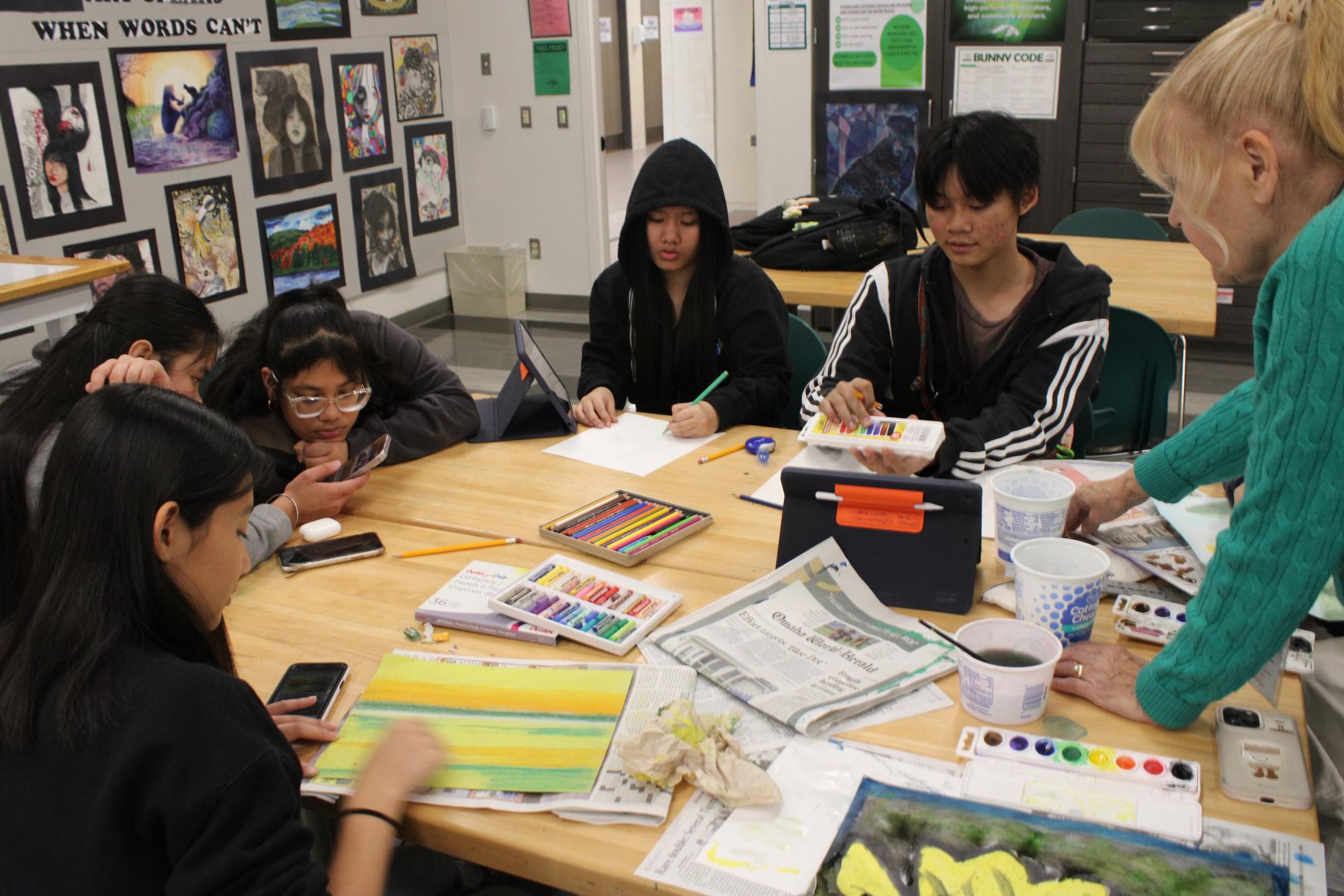 Art teacher Astra Patterson guides students through an art assignment in AP art.