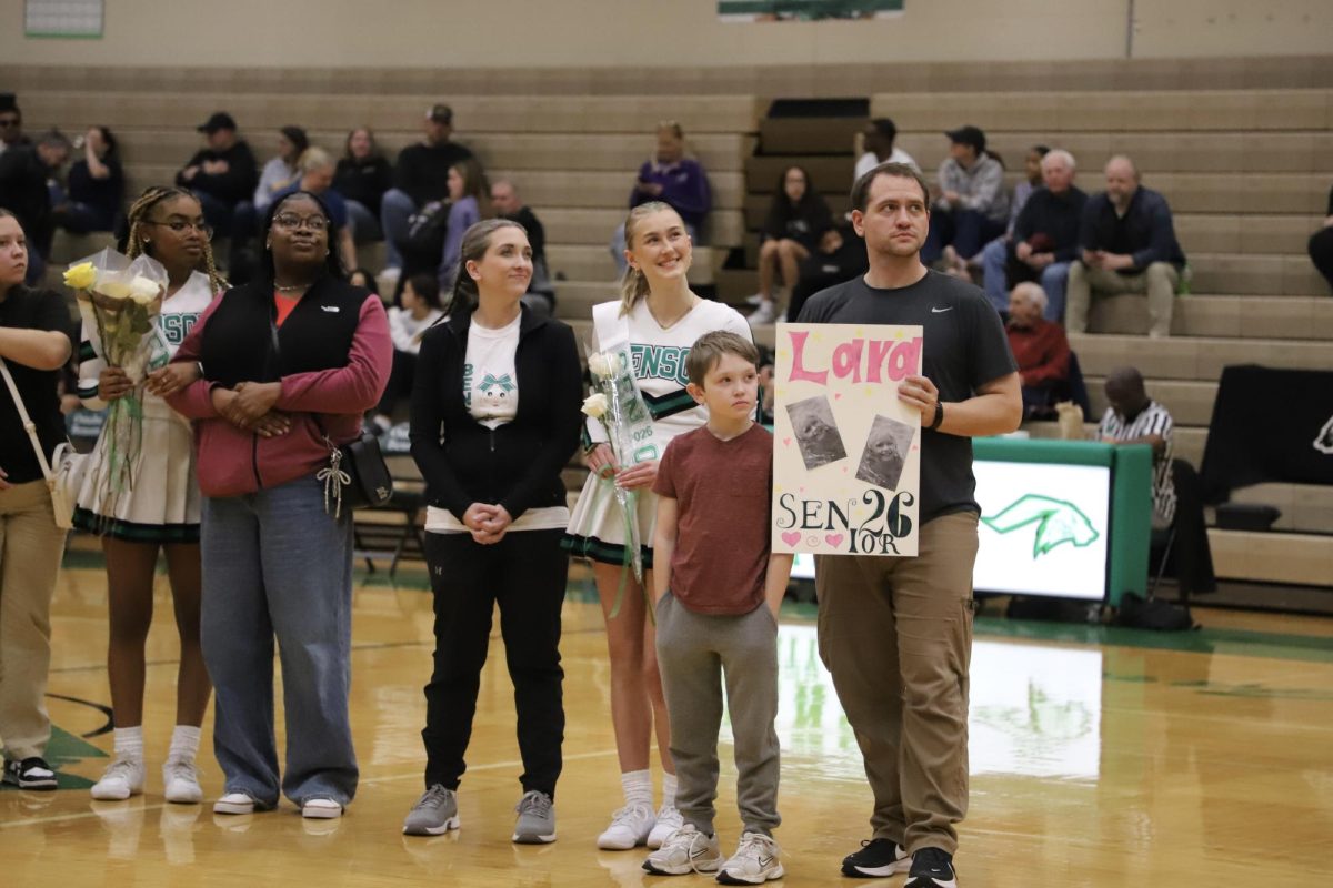 Lara Reimche smiles with exchange family during the senior night memorial video.