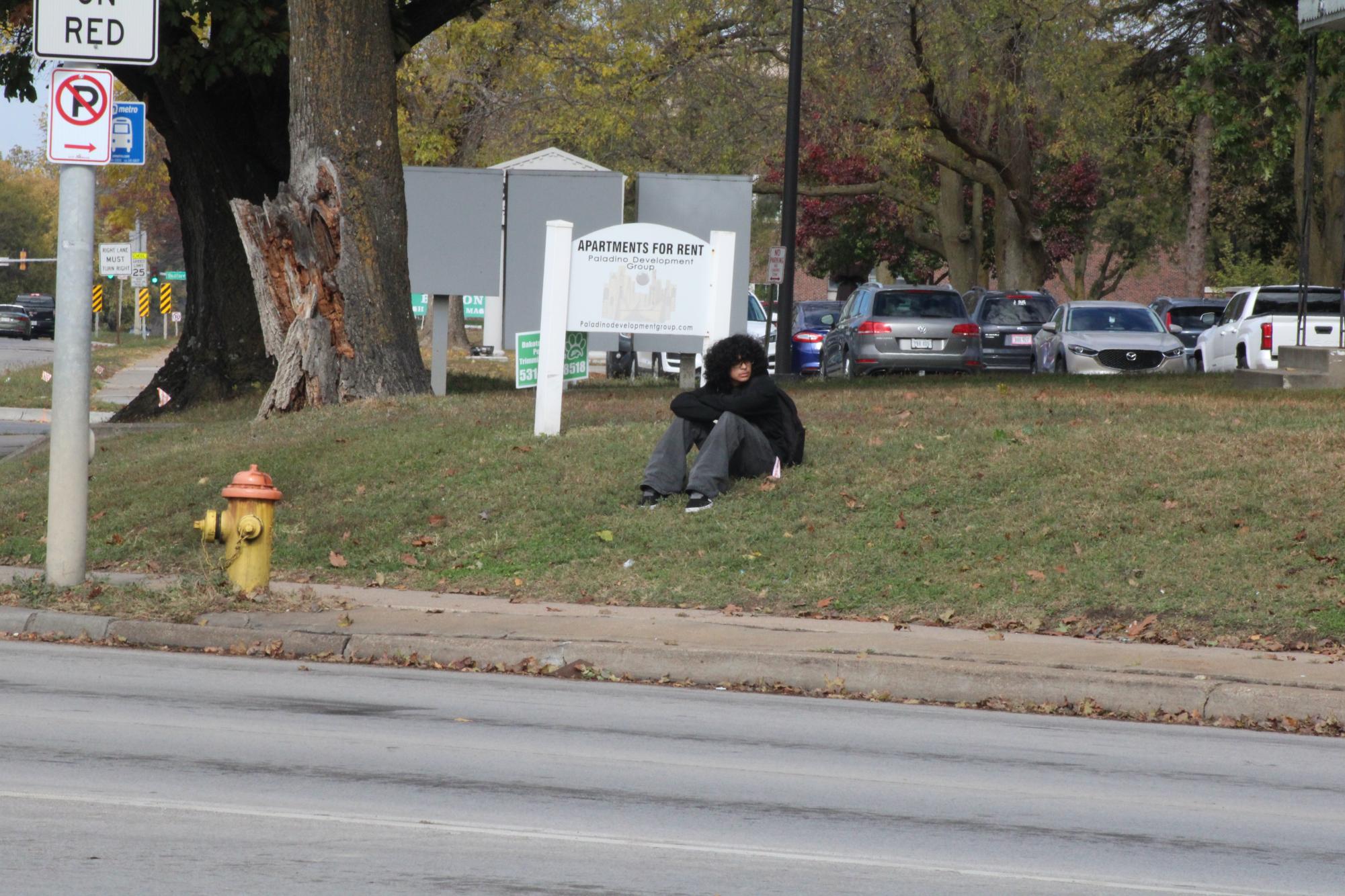 Student waits for a ride following the school day.