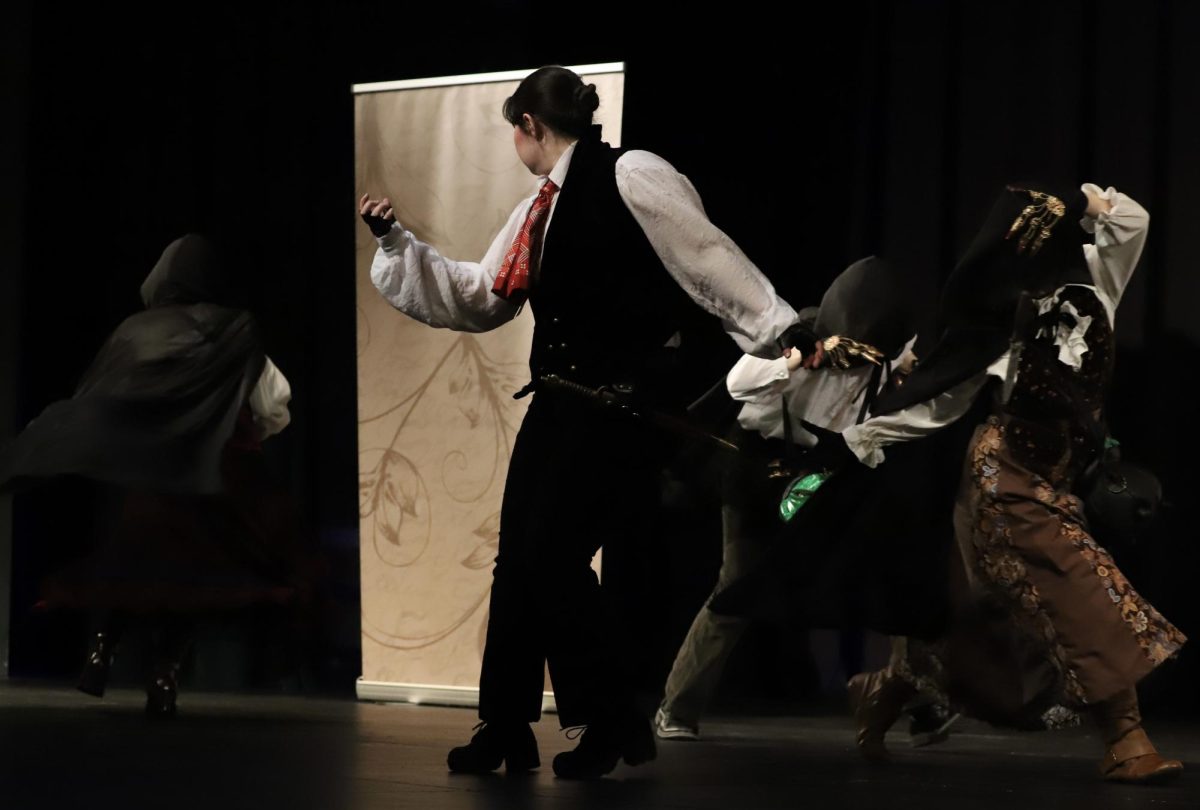 Actors plays in Macbeth during Benson High School performance.